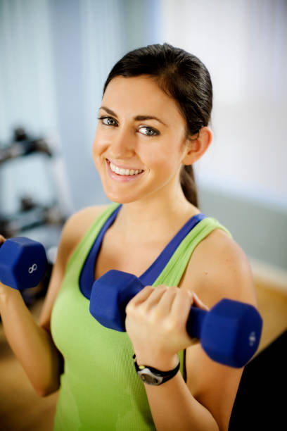 istock Young Woman Doing Arm Curls With Dumbbells 157639128