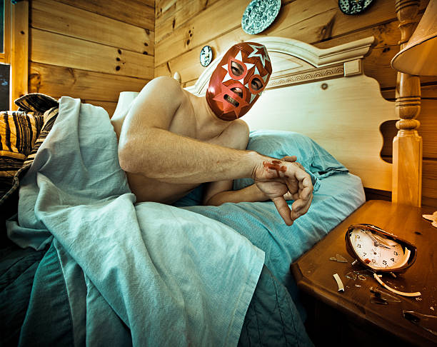 mexican luchador waking up in the morning clock no more - mexican luchador full of pain with wounded hand after smashing an annoying alarm clock early in the morning, dont mess with furio the great sleep! smash alarm clock stock pictures, royalty-free photos & images