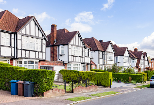 Black and white, Tudor-style detached houses on a suburban street in Hatch End, Harrow, London, UK
