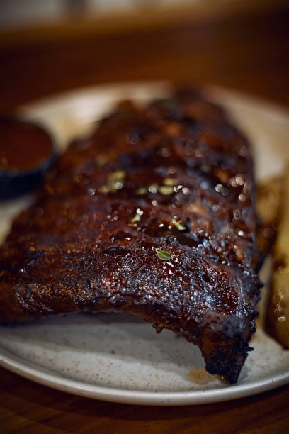 istock Caramelised BBQ Pork Spare Ribs and Potato Wedges 1576393832