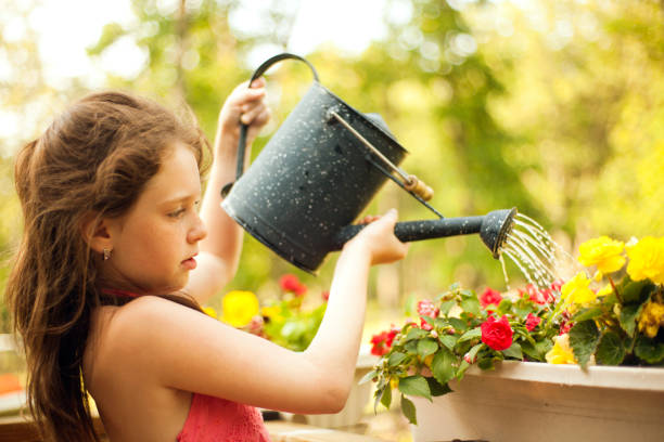 istock girl watering the flowers 157639512