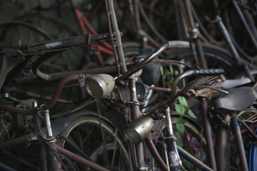Stack of vintage rusty bicycles in the workshop
