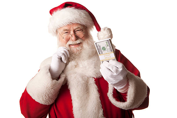 Pictures of Real Santa Claus holding Christmas cash bonus stock photo