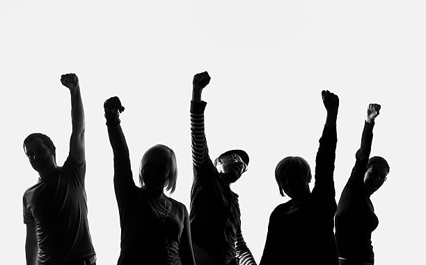 Five silhouettes of people Five silhouettes of people standing in a row and raising their hands. Studio shot on the white background. cheering group of people success looking at camera stock pictures, royalty-free photos & images