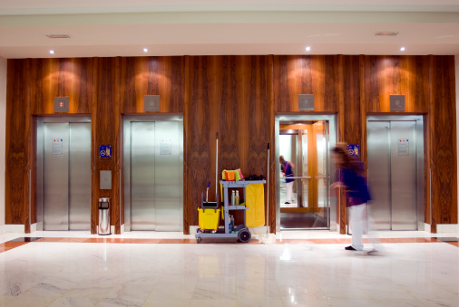 Modern steel elevator cabins in a business lobby or Hotel, Store, interior, office, perspective wide angle with classic wooden style wall. No people