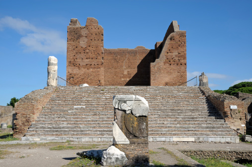 Italy, Rome (Ostia antica): temple erected in honour of Capitoline Triad consisting of Jupiter, Juno and Minerva. (focused on the monument in the foreground)