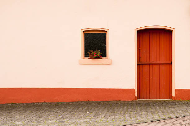 Industrial orange brown metal double swinging closed door in red brick wall. Background replacement
