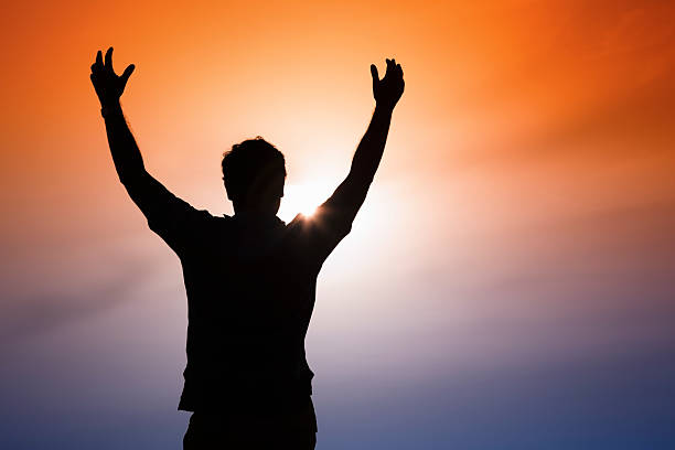 Silhouette of a man at sunset. stock photo