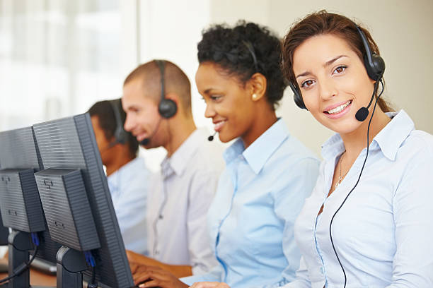istock Smiling call center employees sitting in a row at work 157639937