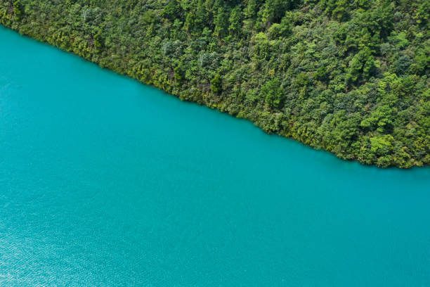 istock Green hills and emerald lake 1576400338