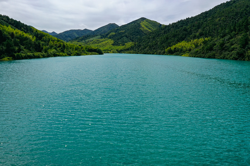 Green hills and emerald lake