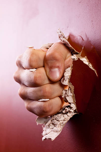 istock Man's fist coming through wall. 157640134