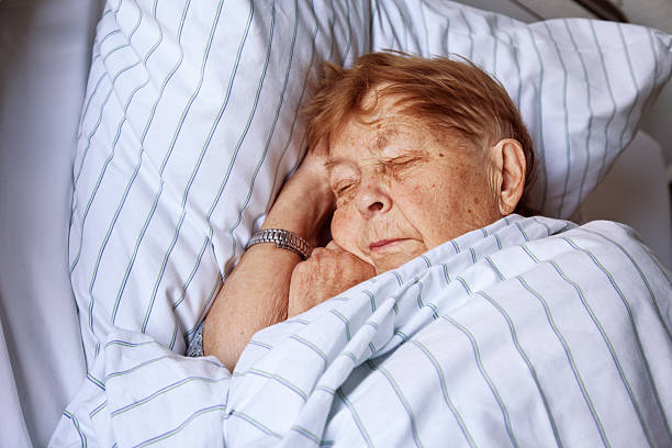 istock senior woman in hospital sleeping 157640144