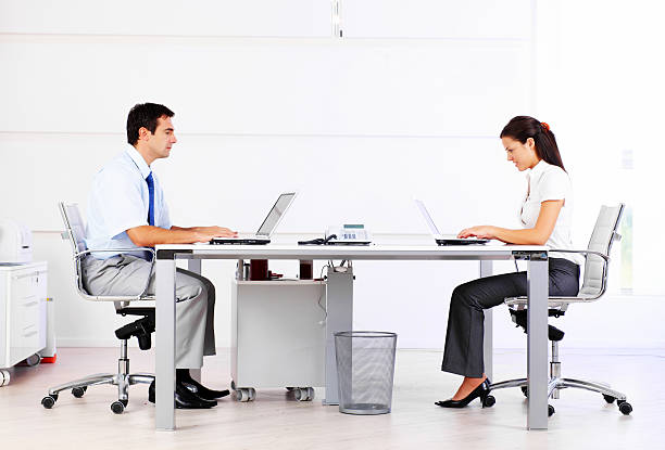 istock Two business people typing on laptop in the office. 157640293