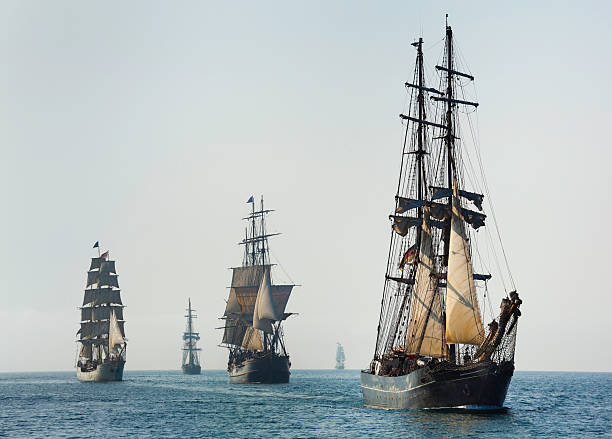 Armada of Tall Ships Sails at Morning Armada of Tall Ships Sails at Morning. This image looks as though it was taken in another time, centuries ago; perfect for the subject matter.  armada stock pictures, royalty-free photos & images