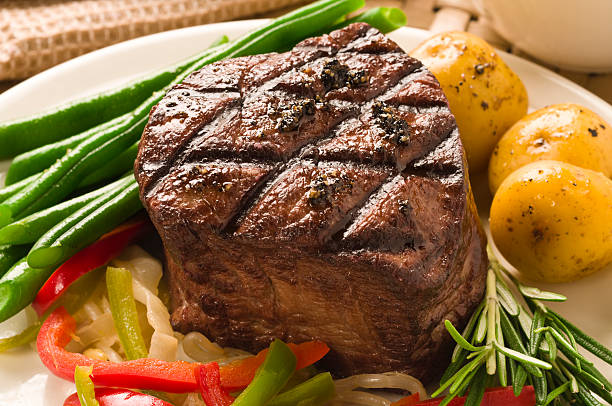 Filet Mignon Served with Potatoes and Cooked Vegetables.
