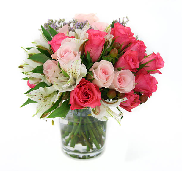 Flower and rose arrangement upright in a glass vase. stock photo
