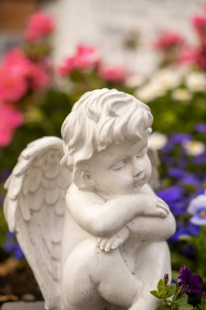 istock Statue of an angel sleeping on a grave. 1576406054