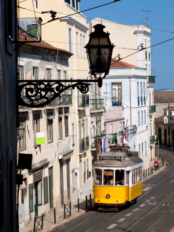 Tram in Lisbon, Portugal with historic lamp silhouette - logos & trademarks removed