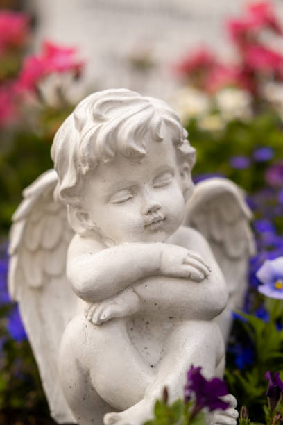 istock Statue of an angel sleeping on a grave. 1576406558