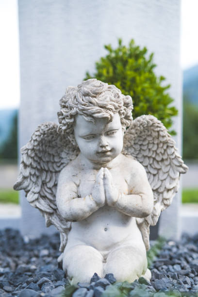 istock Statue of an angel on a grave. 1576407180