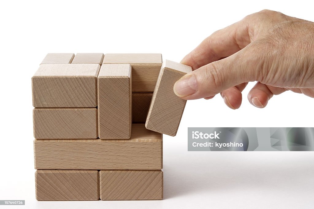 Isolated shot of holding a wood block on white background Holding a wood block isolated on white background. Creativity Stock Photo