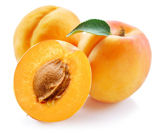 istock Ripe apricots with green leaf and apricot half isolated on white background. 1576407748