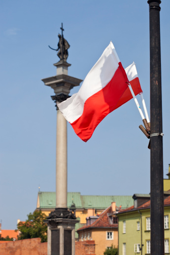 The Polish Flag With The King Zygamunt Column (From 1644) In The Background From Warsaw, Poland