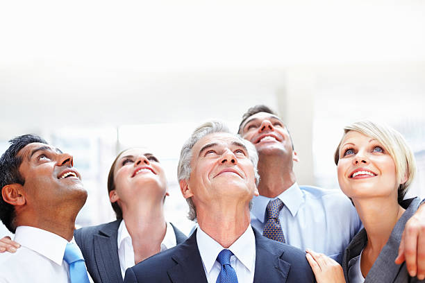 istock Group of business executives looking up at copy space 157640940