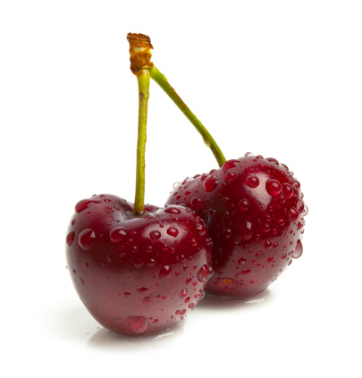 Two organic red bing cherries covered with water droplets - isolated over 100% white background. Canon 5D MarkII.