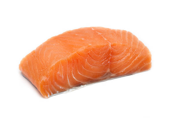 A large pink salmon fillet isolated on a white background Raw salmon fillet salmon seafood stock pictures, royalty-free photos & images