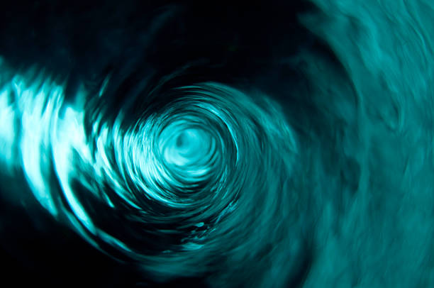 A beautiful clear teal water vortex stock photo