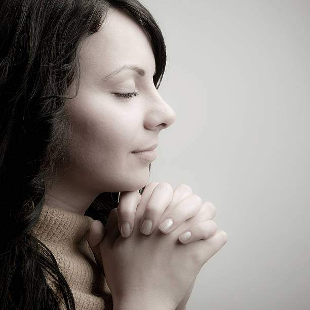 istock Young girl praying 157641517