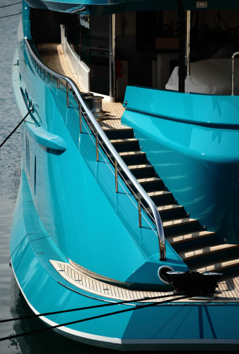 View of the aft deck and stairs on a large blue super yacht moored in Antibes, France.  Polarized filter used. Please see my other 'Blue Yacht Hull' photos here... 