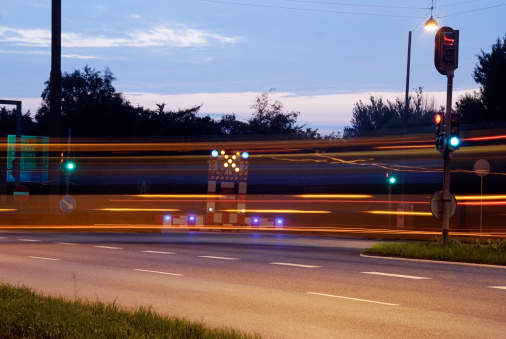 Roadblock and motion blurred bus passing in the night