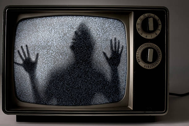 man trapped inside television stock photo