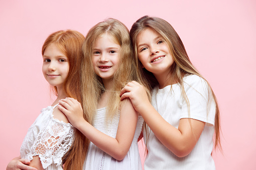 Studio shot portrait of a beautiful happy child sisters