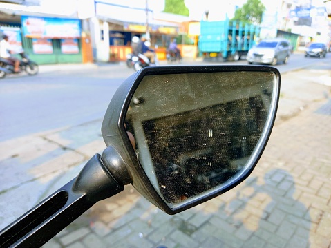 Close-up of a motorcycle mirror.