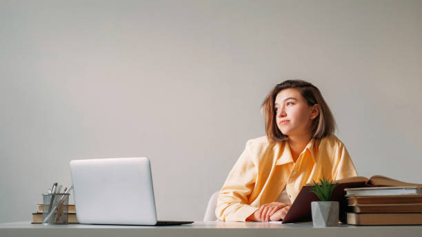 istock Laptop studying pensive freelancer thoughtful girl 1576420619