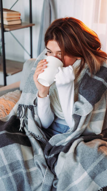 istock Blanket warm tea break drinking shivering woman 1576420797