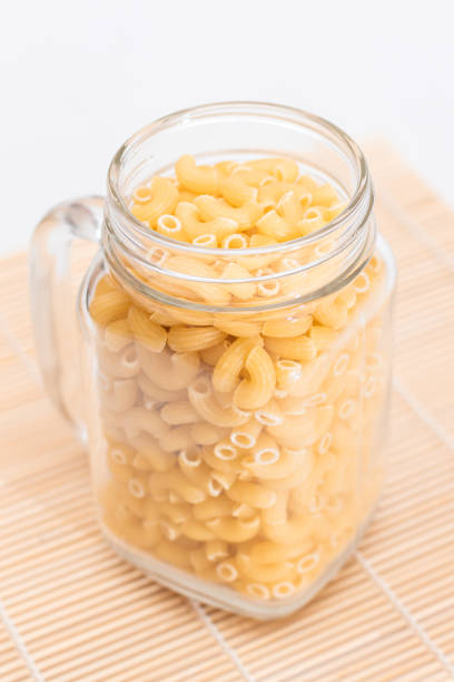 istock Uncooked Chifferi Rigati Pasta in Glass Jar on Bamboo Mat 1576421164