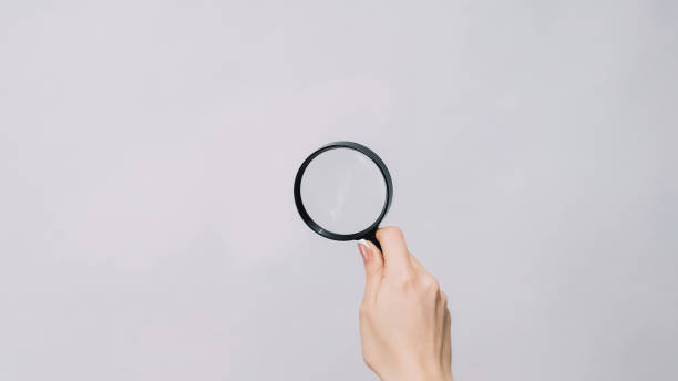 istock Zooming glass exploring lens woman hand studying 1576422267