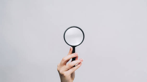 istock Magnifying glass zooming tool woman hand exploring 1576422269
