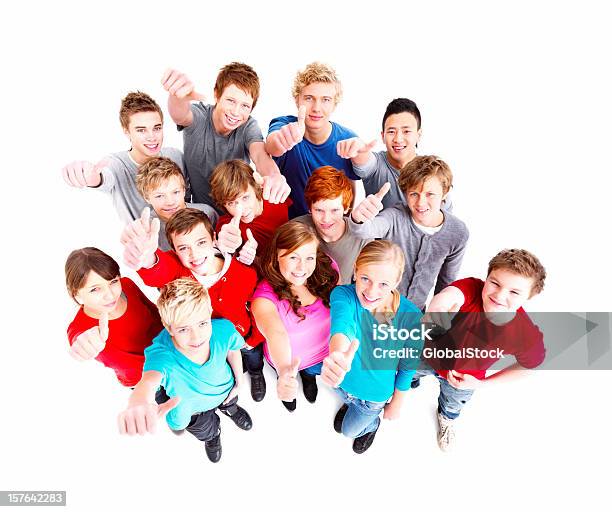 Group Of Happy Teenagers With Thumbs Up Sign Against White Stock Photo - Download Image Now