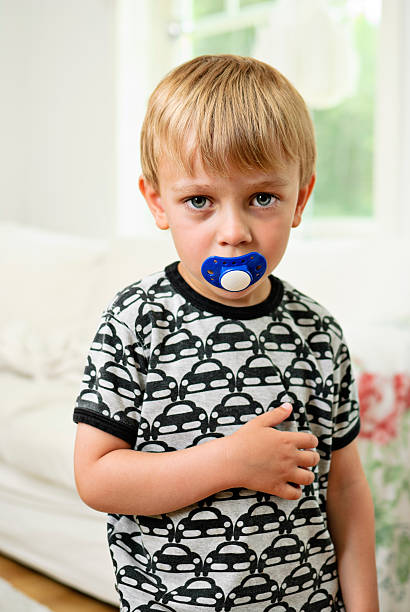 istock Young Boy with Pacifier in Livingroom 157642300
