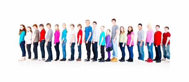istock Smiling teenagers standing in a row against white 157642343