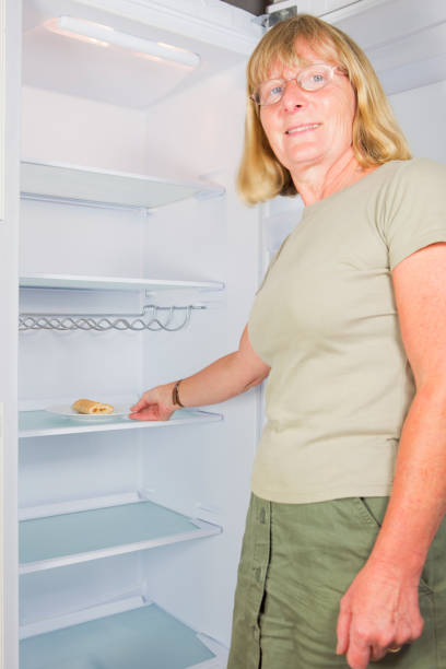 istock Lady Taking The Last Food From A Fridge 157642577