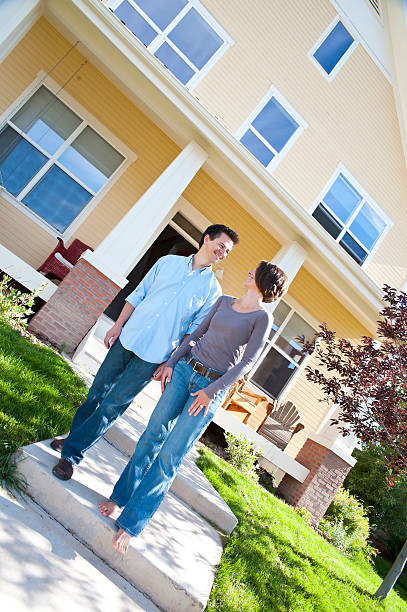 istock Married couple standing outside of first home 157642948