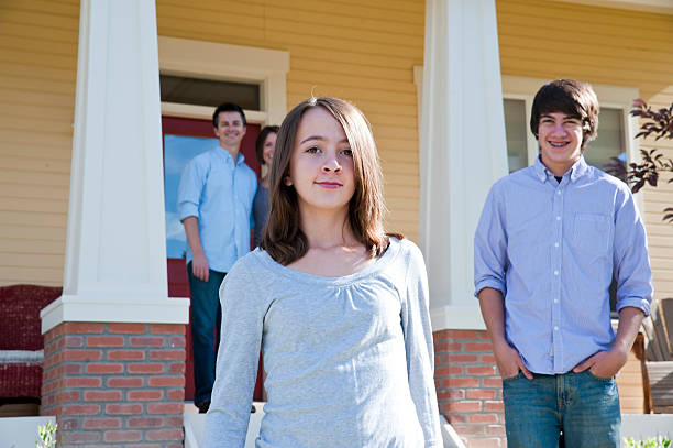 istock Children in front of home with parents behind on deck 157642970
