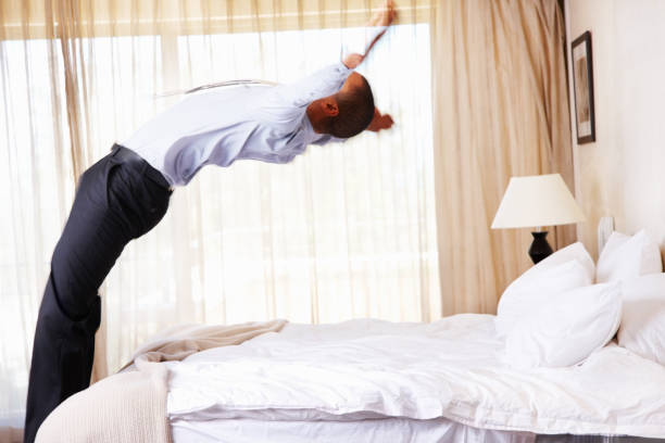 istock Tired businessman jumping in bed at home 157643077
